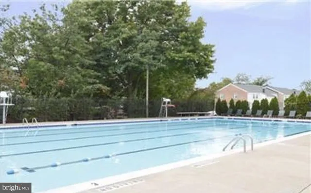 a view of a patio with a table and chairs and floor to ceiling window