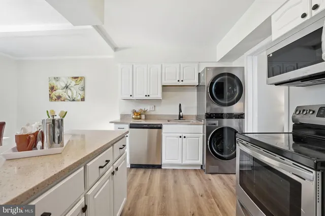 a kitchen with a stove top oven sink and cabinets