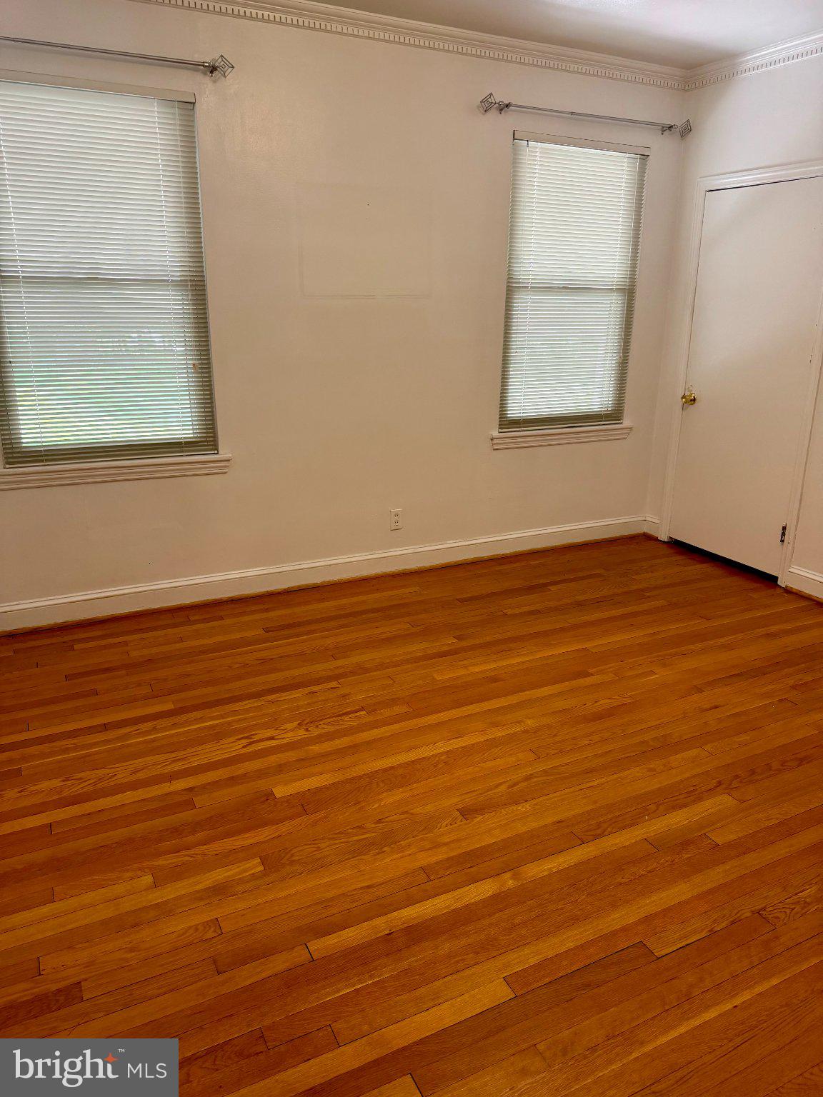 6318 Winner Avenue Baltimore, MD 21215 - Photo 30 of 75 an empty room with wooden floor and windows