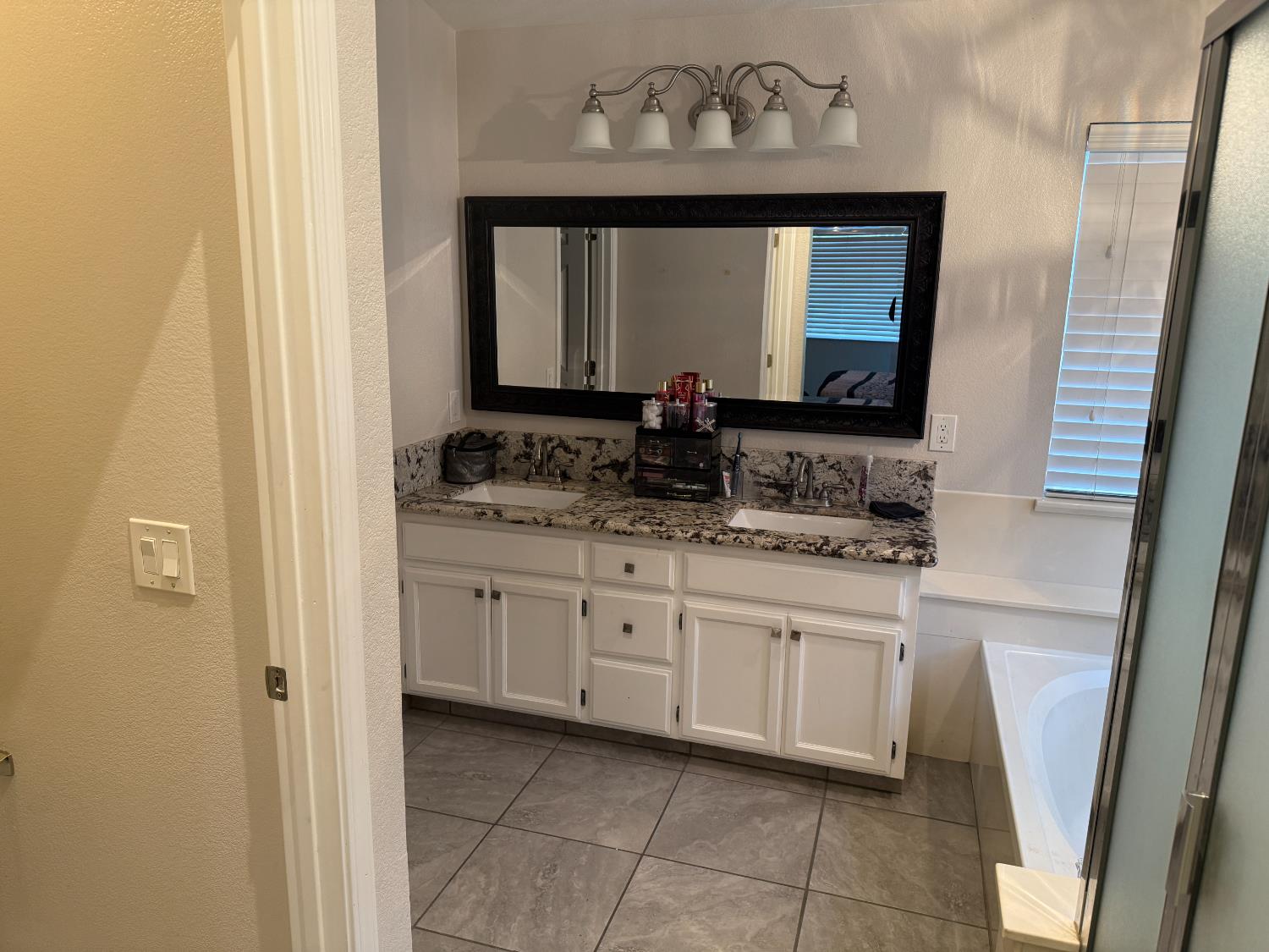 16432 Harmony Ranch Drive Delhi, CA 95315 - Photo 12 of 19 a bathroom with a sink and a mirror
