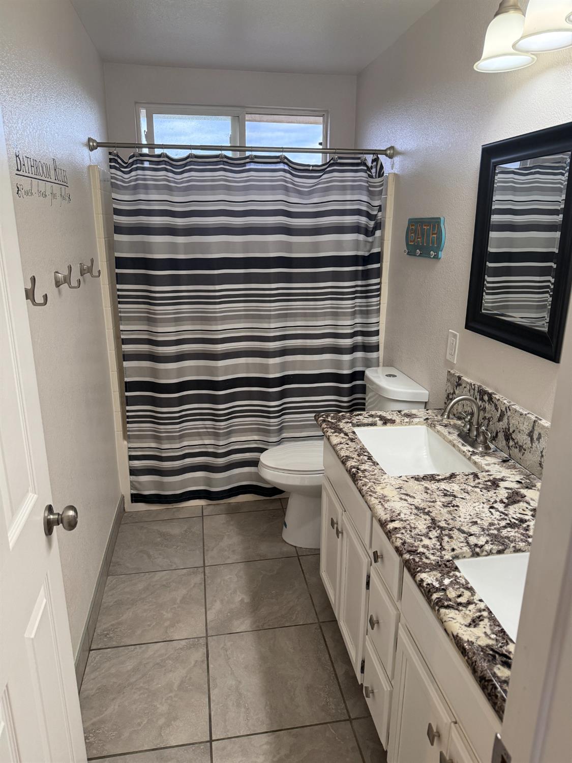 16432 Harmony Ranch Drive Delhi, CA 95315 - Photo 14 of 19 a bathroom with a granite countertop sink toilet and shower