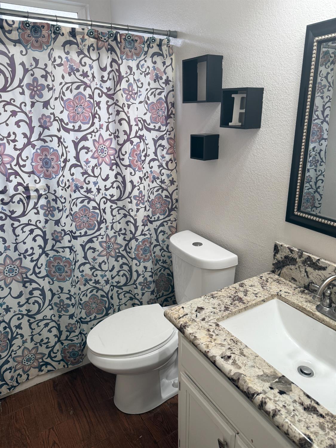 16432 Harmony Ranch Drive Delhi, CA 95315 - Photo 17 of 19 a bathroom with a granite countertop toilet and a sink