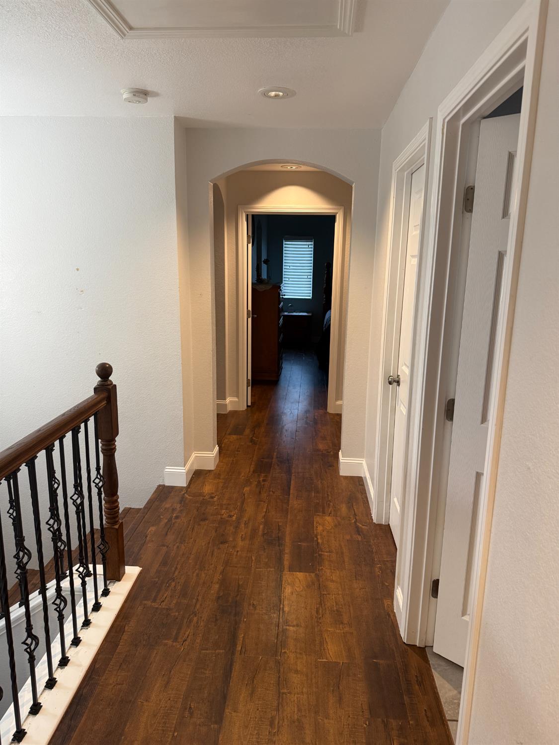 16432 Harmony Ranch Drive Delhi, CA 95315 - Photo 9 of 19 a view of a hallway with wooden floor and staircase