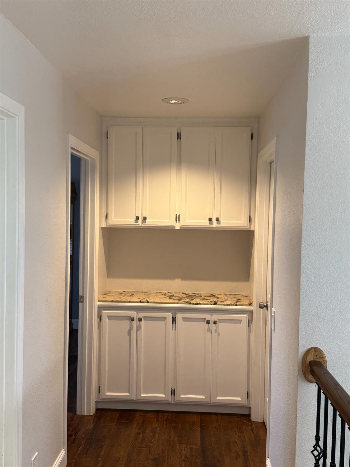 16432 Harmony Ranch Drive Delhi, CA 95315 - Photo 10 of 19 a view of a kitchen with white cabinets and wooden floor