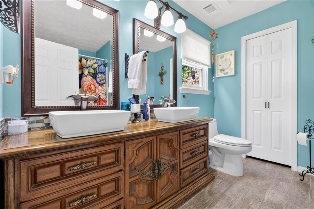 3771 Castleberry Road Cumming, GA 30040 - Photo 28 of 69 a bathroom with a sink a toilet and a mirror