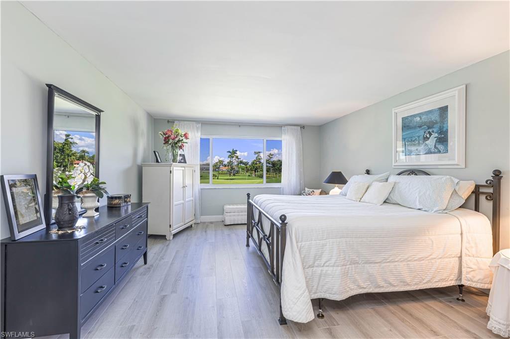230 Albi Road, Unit 2494 Naples, FL 34112 - Photo 12 of 22 Bedroom with light wood-type flooring