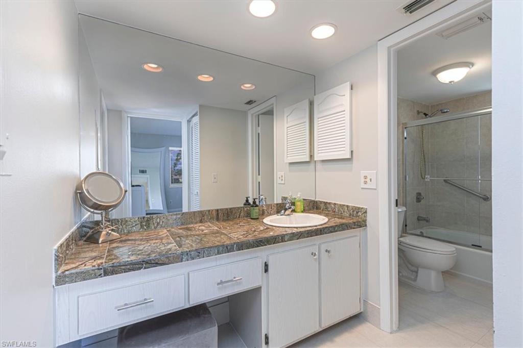230 Albi Road, Unit 2494 Naples, FL 34112 - Photo 14 of 22 Bathroom featuring vanity, shower / bath combination with glass door, light tile patterned floors, and recessed lighting