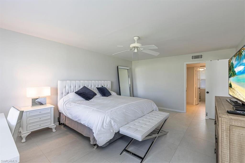 230 Albi Road, Unit 2494 Naples, FL 34112 - Photo 15 of 22 Bedroom with a ceiling fan and baseboards