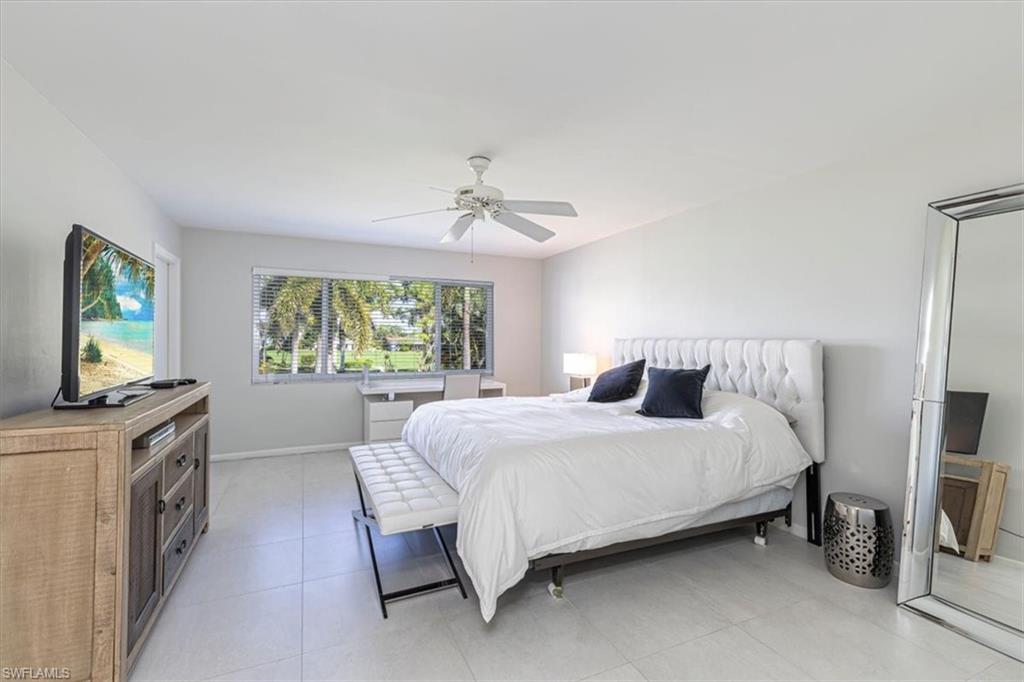 230 Albi Road, Unit 2494 Naples, FL 34112 - Photo 16 of 22 Bedroom with ceiling fan and light tile patterned floors