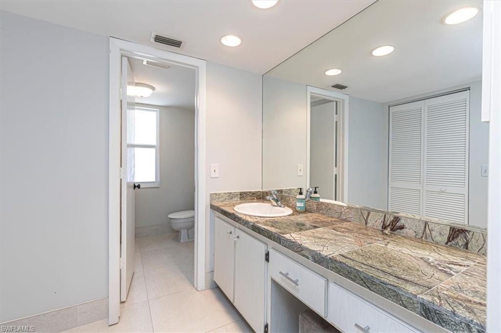 230 Albi Road, Unit 2494 Naples, FL 34112 - Photo 17 of 22 Bathroom with vanity, light tile patterned floors, and recessed lighting