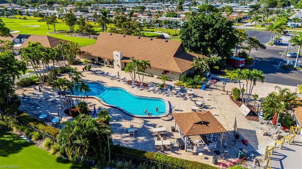 230 Albi Road, Unit 2494 Naples, FL 34112 - Photo 18 of 22 Community pool featuring a patio, a residential view, and golf course view