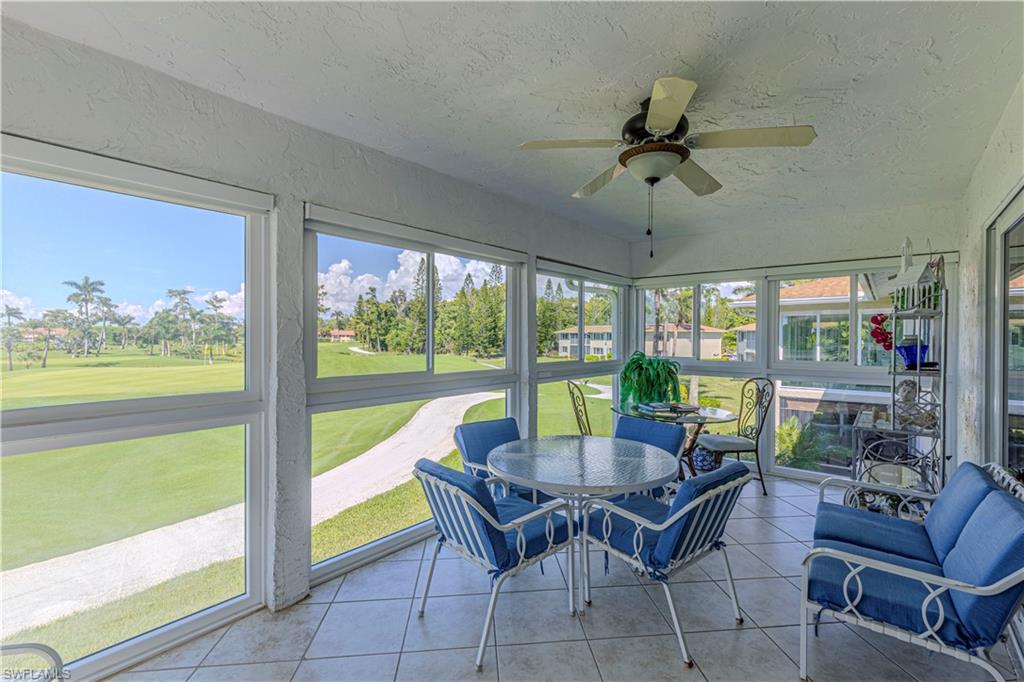 230 Albi Road, Unit 2494 Naples, FL 34112 - Photo 6 of 22 Sunroom / solarium featuring a ceiling fan, view of golf course, and plenty of natural light