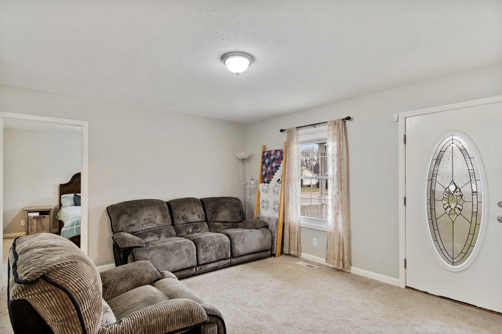 115 Poplar Street Portland, TN 37148 - Photo 13 of 17 a living room with furniture a mirror and a couch