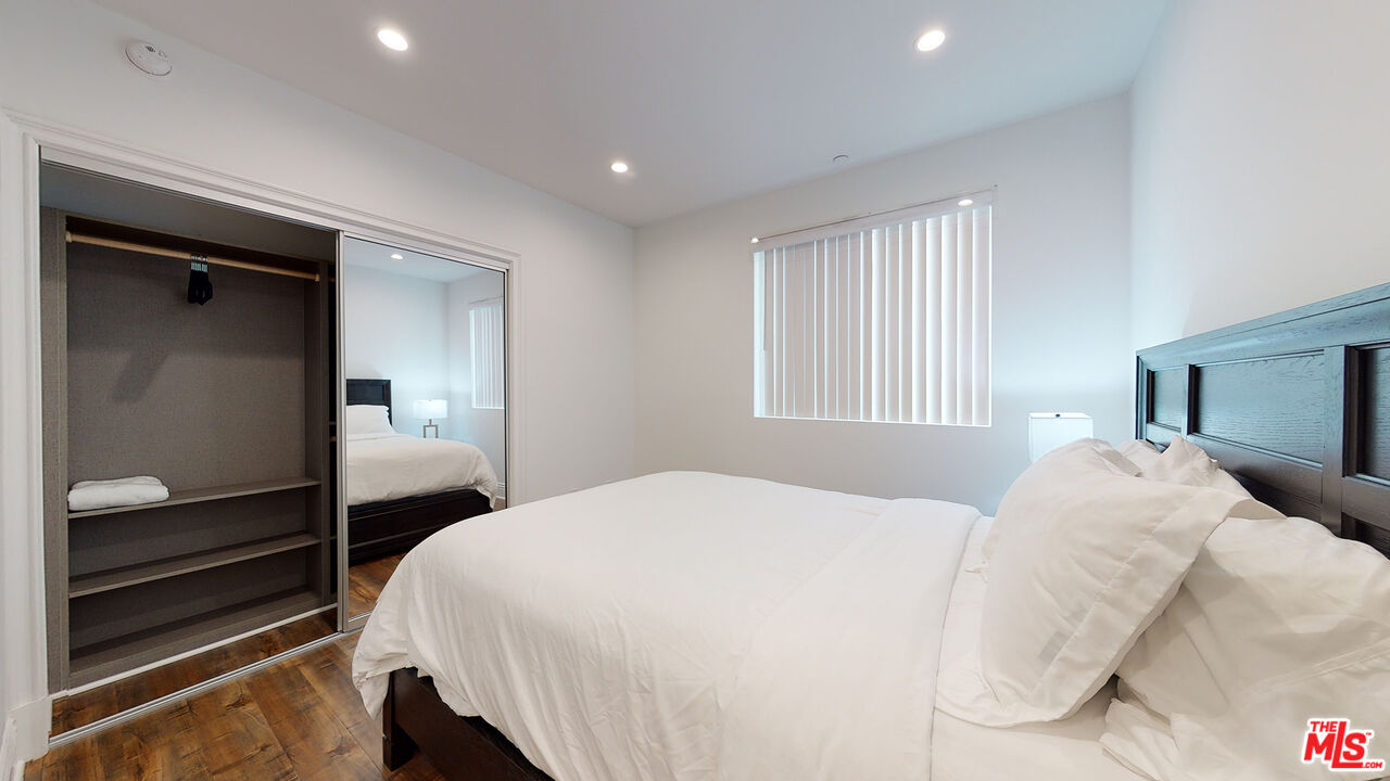 907 South Shenandoah Street, Unit 101 Los Angeles, CA 90035 - Photo 14 of 39 a bedroom with a bed and a window