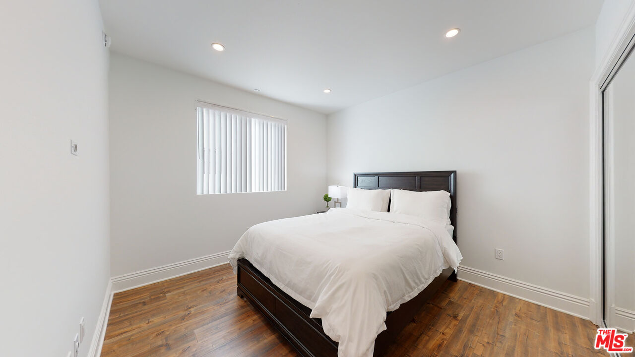 907 South Shenandoah Street, Unit 101 Los Angeles, CA 90035 - Photo 16 of 39 a large bed sitting in a bedroom next to a window