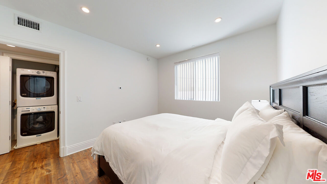 907 South Shenandoah Street, Unit 101 Los Angeles, CA 90035 - Photo 18 of 39 a bedroom with a large bed and a tv