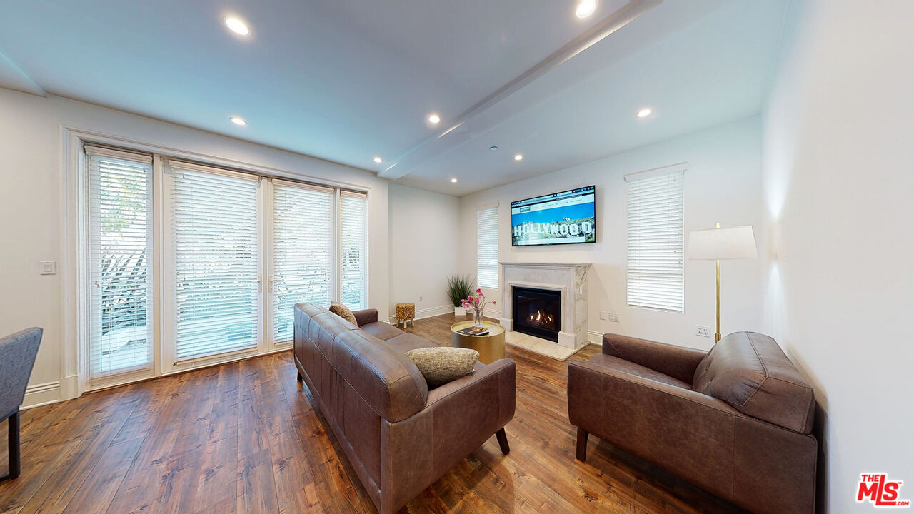 907 South Shenandoah Street, Unit 101 Los Angeles, CA 90035 - Photo 2 of 39 a living room with furniture and a fireplace