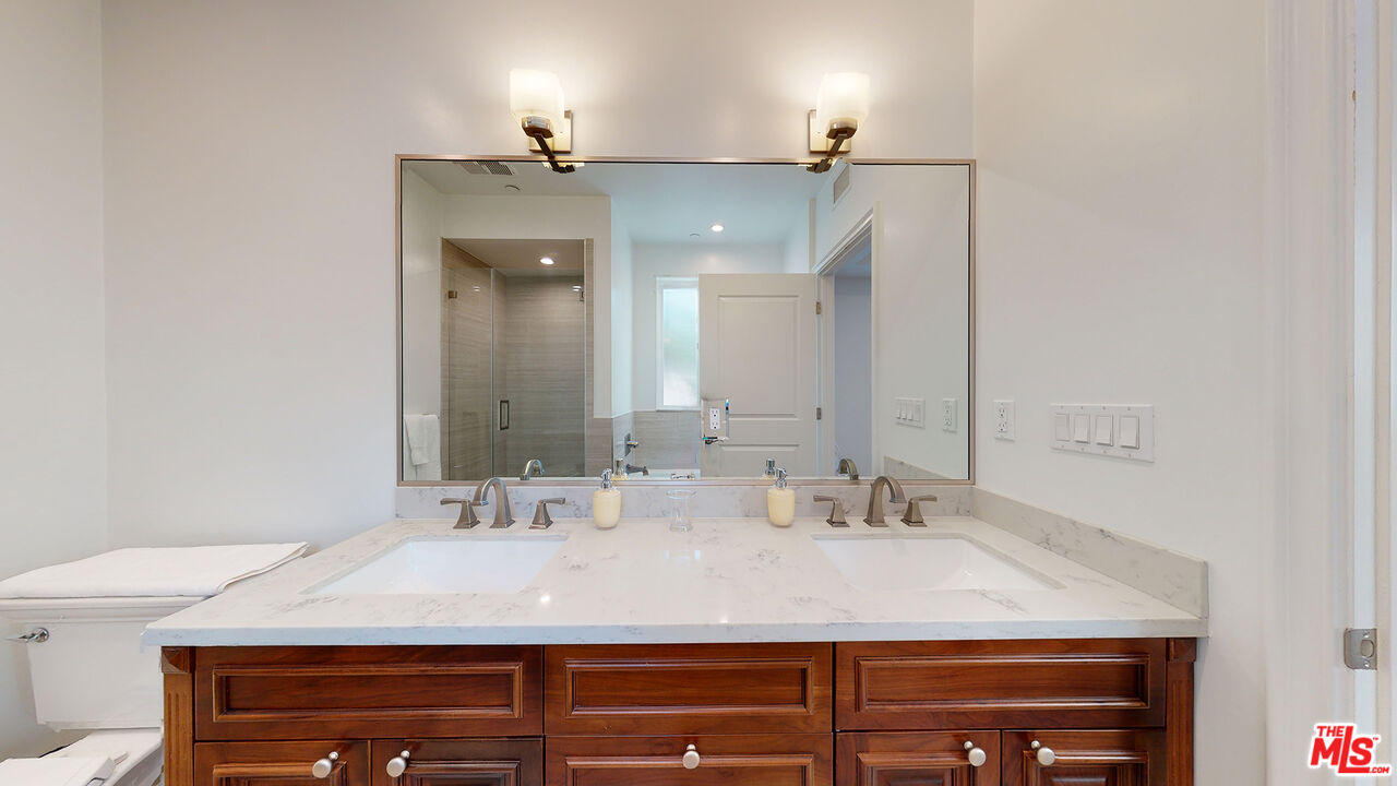 907 South Shenandoah Street, Unit 101 Los Angeles, CA 90035 - Photo 26 of 39 a bathroom with a sink and a mirror