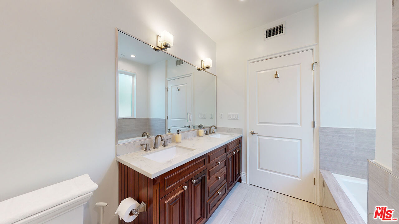 907 South Shenandoah Street, Unit 101 Los Angeles, CA 90035 - Photo 29 of 39 a bathroom with a sink double vanity and a mirror