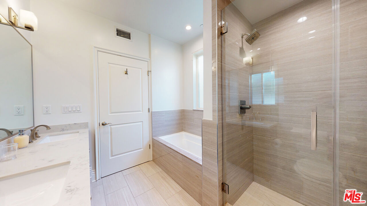 907 South Shenandoah Street, Unit 101 Los Angeles, CA 90035 - Photo 30 of 39 a bathroom with a tub shower and sink