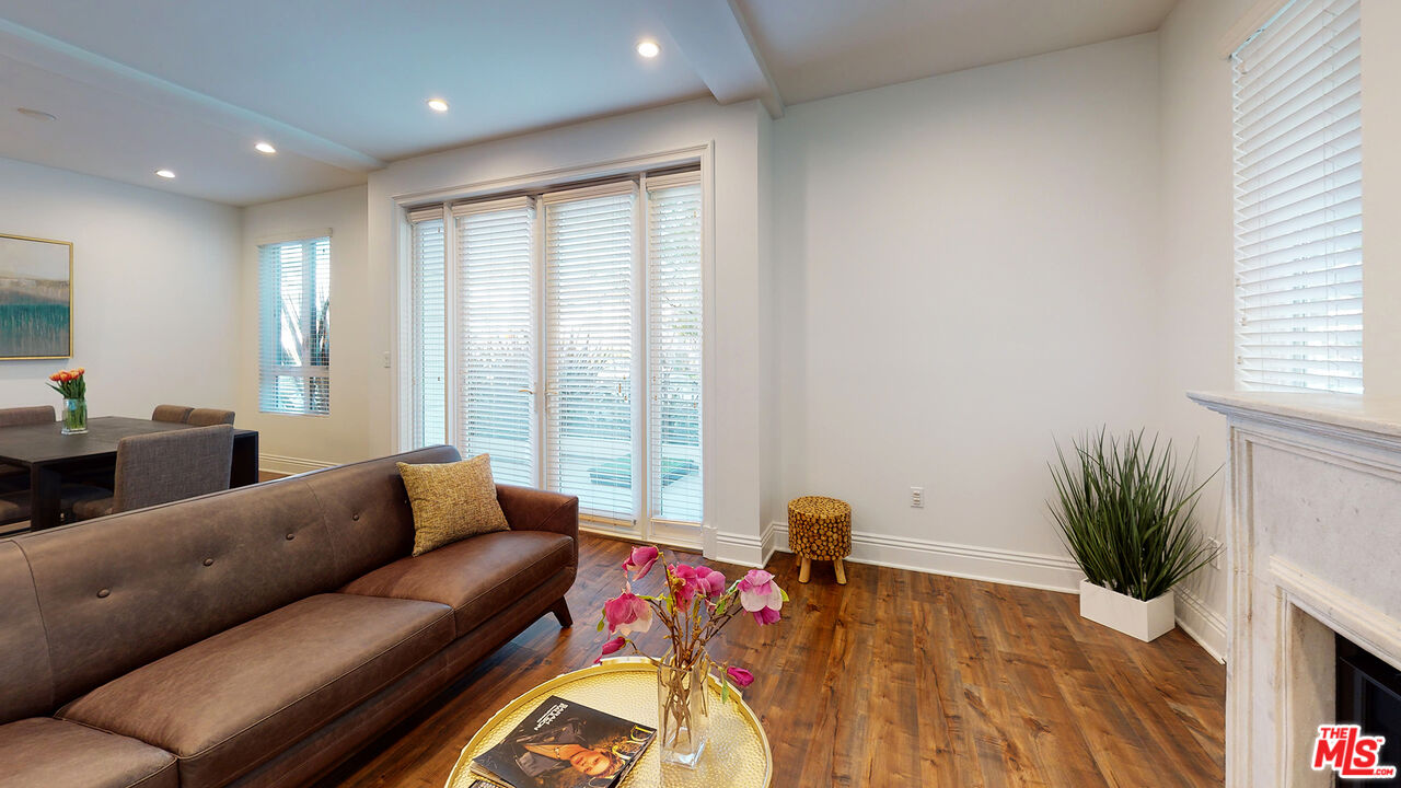 907 South Shenandoah Street, Unit 101 Los Angeles, CA 90035 - Photo 3 of 39 a living room with furniture and a flat screen tv