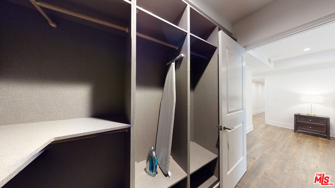 907 South Shenandoah Street, Unit 101 Los Angeles, CA 90035 - Photo 32 of 39 a view of walk in closet with clothes and shoes