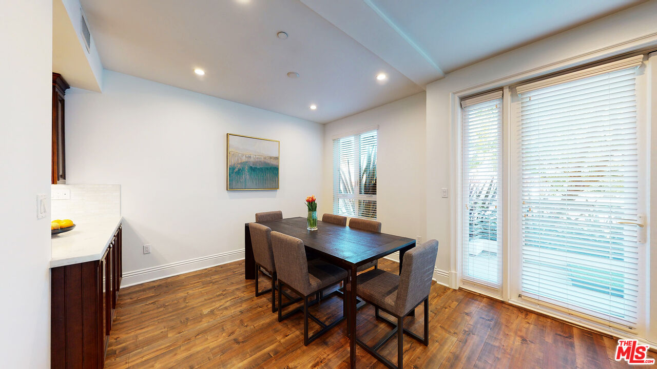 907 South Shenandoah Street, Unit 101 Los Angeles, CA 90035 - Photo 5 of 39 a workspace with furniture and wooden floor