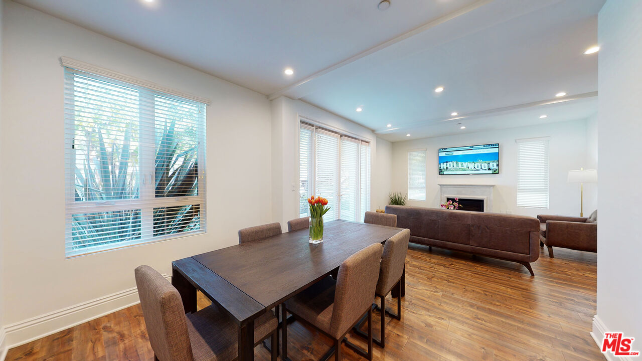 907 South Shenandoah Street, Unit 101 Los Angeles, CA 90035 - Photo 6 of 39 a living room with furniture a wooden floor and a window