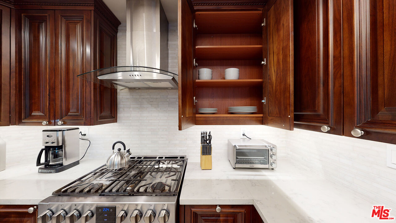 907 South Shenandoah Street, Unit 101 Los Angeles, CA 90035 - Photo 7 of 39 a kitchen with granite countertop a stove and cabinets