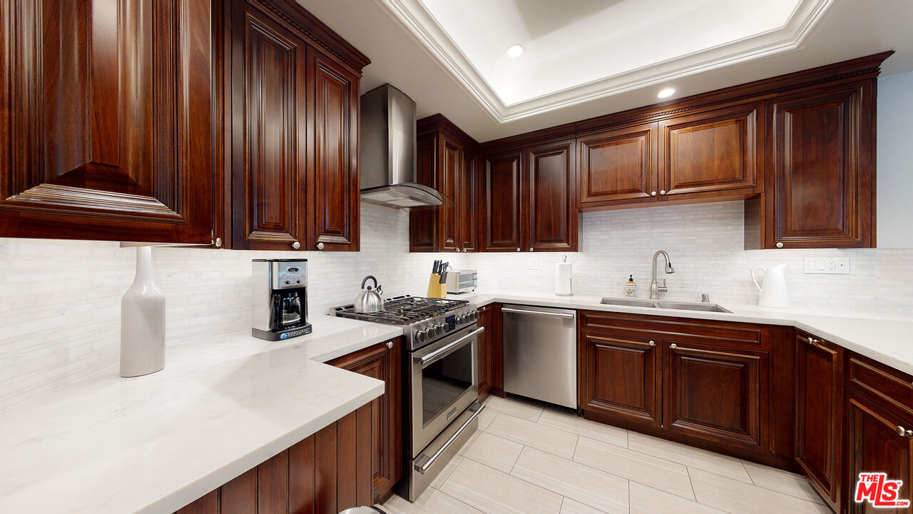 907 South Shenandoah Street, Unit 101 Los Angeles, CA 90035 - Photo 8 of 39 a kitchen with a sink and wooden cabinets