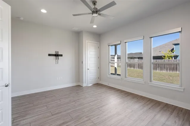 an empty room with windows and stairs