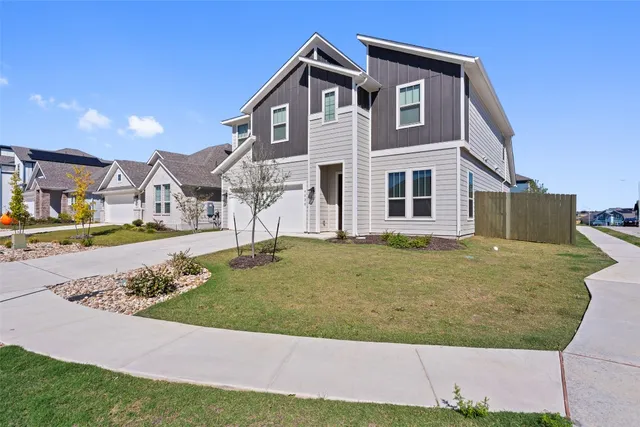 a view of a kitchen with a sink and dishwasher a refrigerator with wooden floor