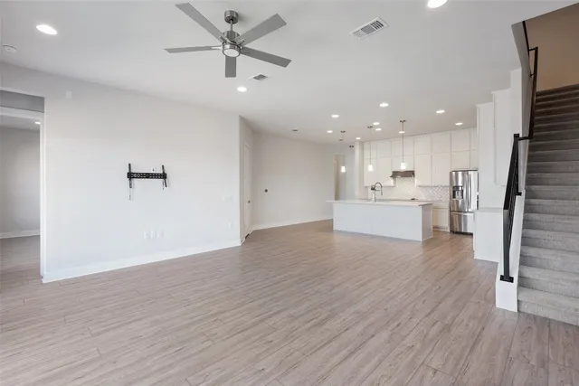 a kitchen with stainless steel appliances white cabinets and a refrigerator