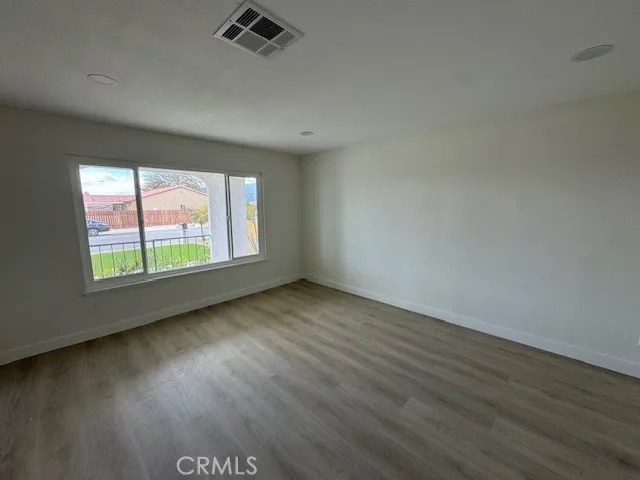 a front view of a house with a garden and yard