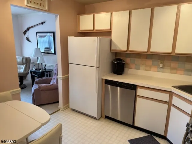 a kitchen with furniture a refrigerator and a sink