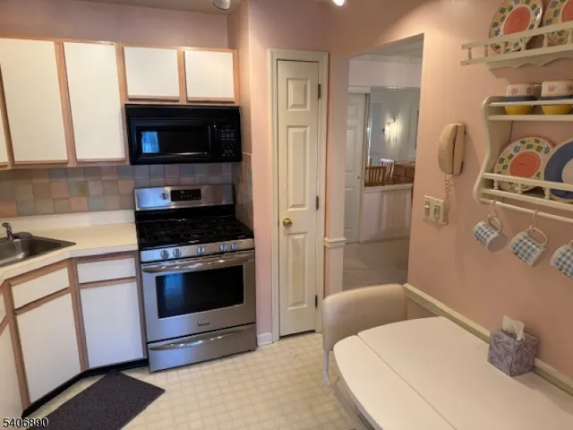 a kitchen with a stove and a microwave
