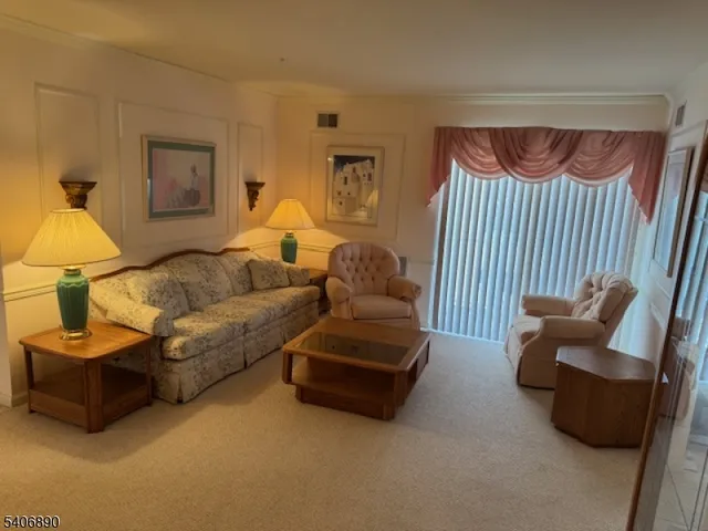 a living room with furniture and a lamp