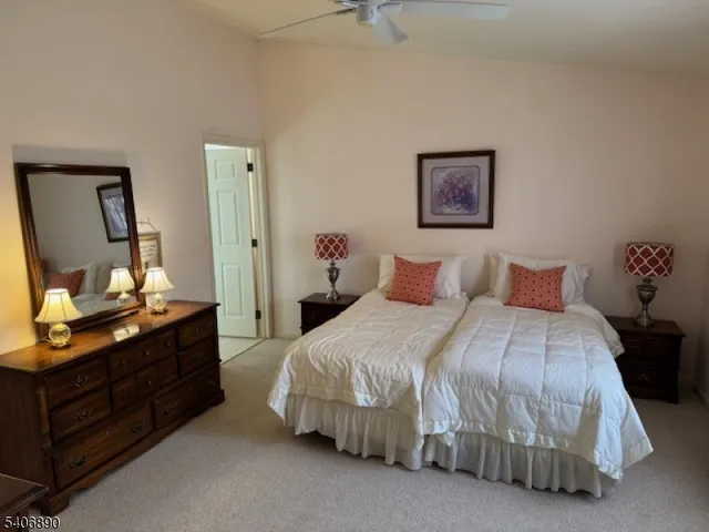 a bedroom with a bed and a mirror on dresser