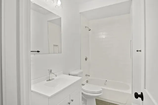 a kitchen with a refrigerator a sink and cabinets