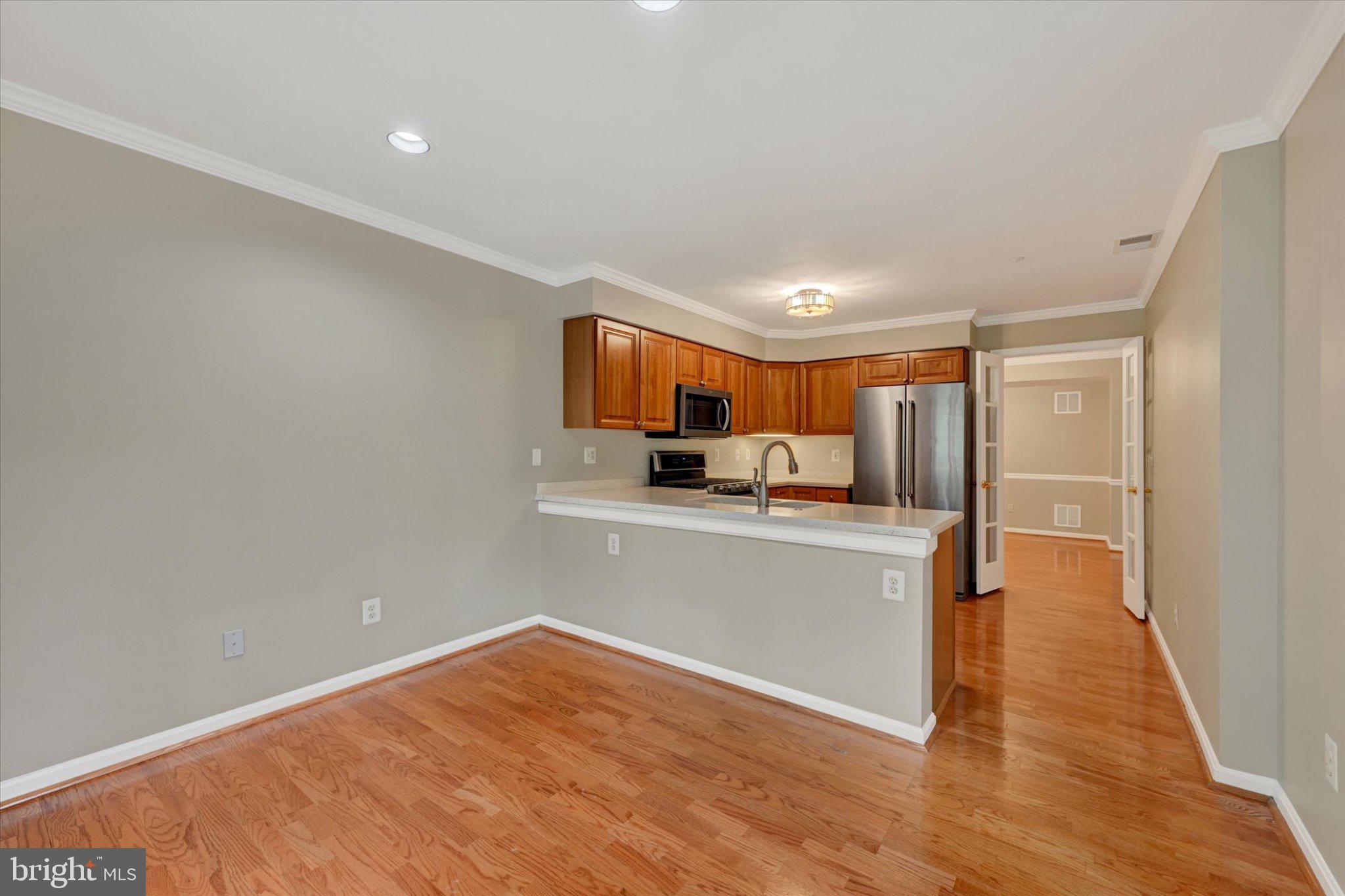 12310 Rosslare Ridge Road, Unit 405 Lutherville-Timonium, MD 21093 - Photo 17 of 36 Modern kitchen with warm wood accents.
