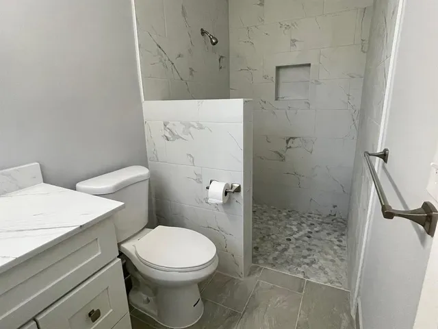 a bathroom with a toilet and shower