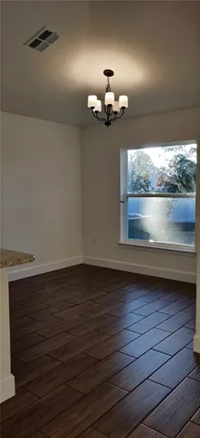 an empty room with wooden floor