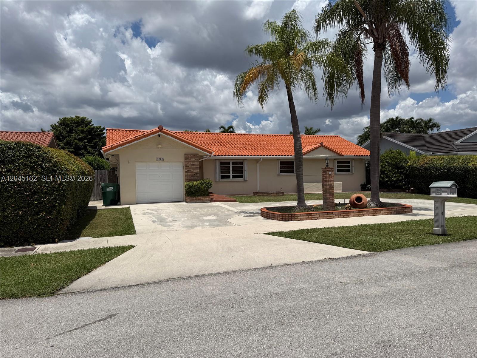 3262 Southwest 139th Place Miami, FL 33175 - Photo 1 of 36 a view of a house with a yard and palm trees
