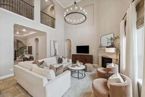 a view of a dining room with furniture and chandelier
