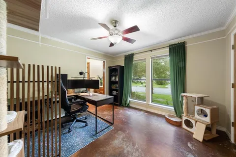 a view of a workspace with furniture and a window