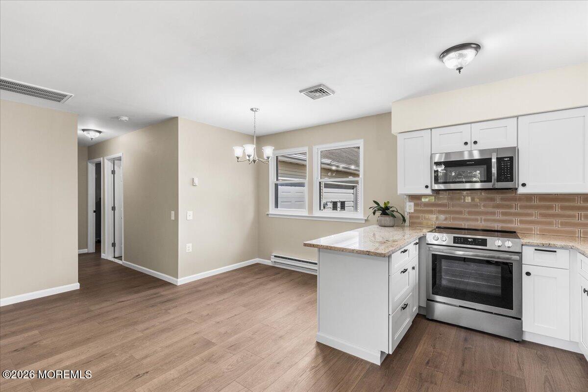 16 D Spring Street, Unit 50 Whiting, NJ 08759 - Photo 16 of 28 a kitchen with stainless steel appliances granite countertop a stove a sink and a refrigerator