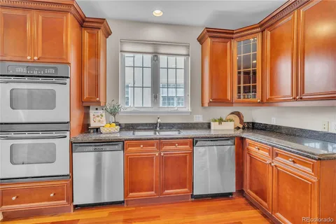 a bathroom with a double vanity sink a mirror and a bathtub