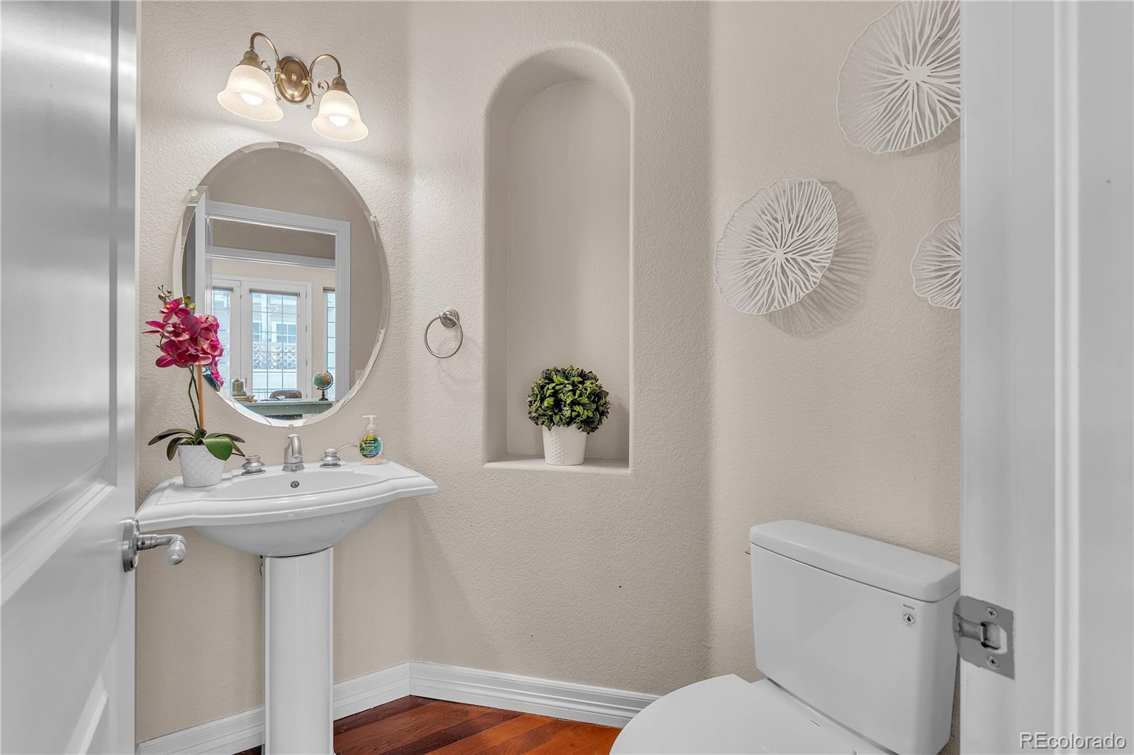 8053 East Maple Avenue Denver, CO 80230 - Photo 19 of 49 a bathroom with a sink and a mirror