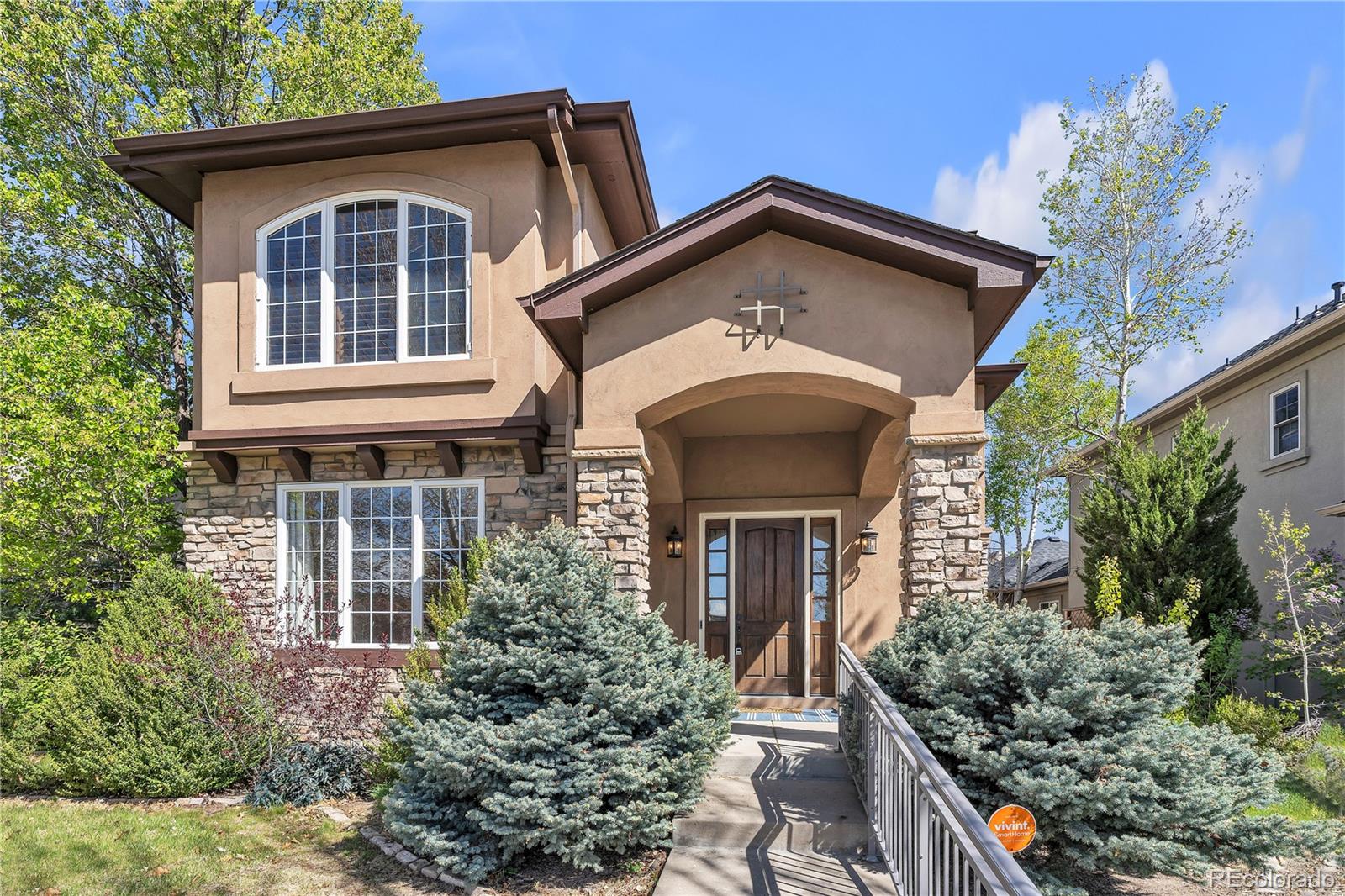 8053 East Maple Avenue Denver, CO 80230 - Photo 2 of 49 a front view of a house with garden