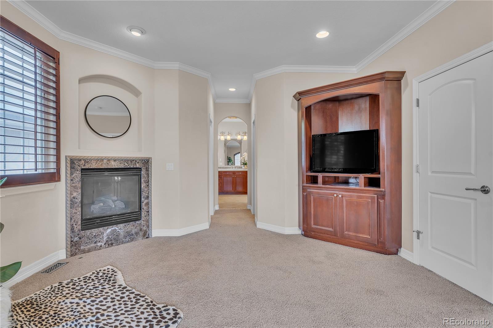8053 East Maple Avenue Denver, CO 80230 - Photo 24 of 49 a living room with furniture and a flat screen tv